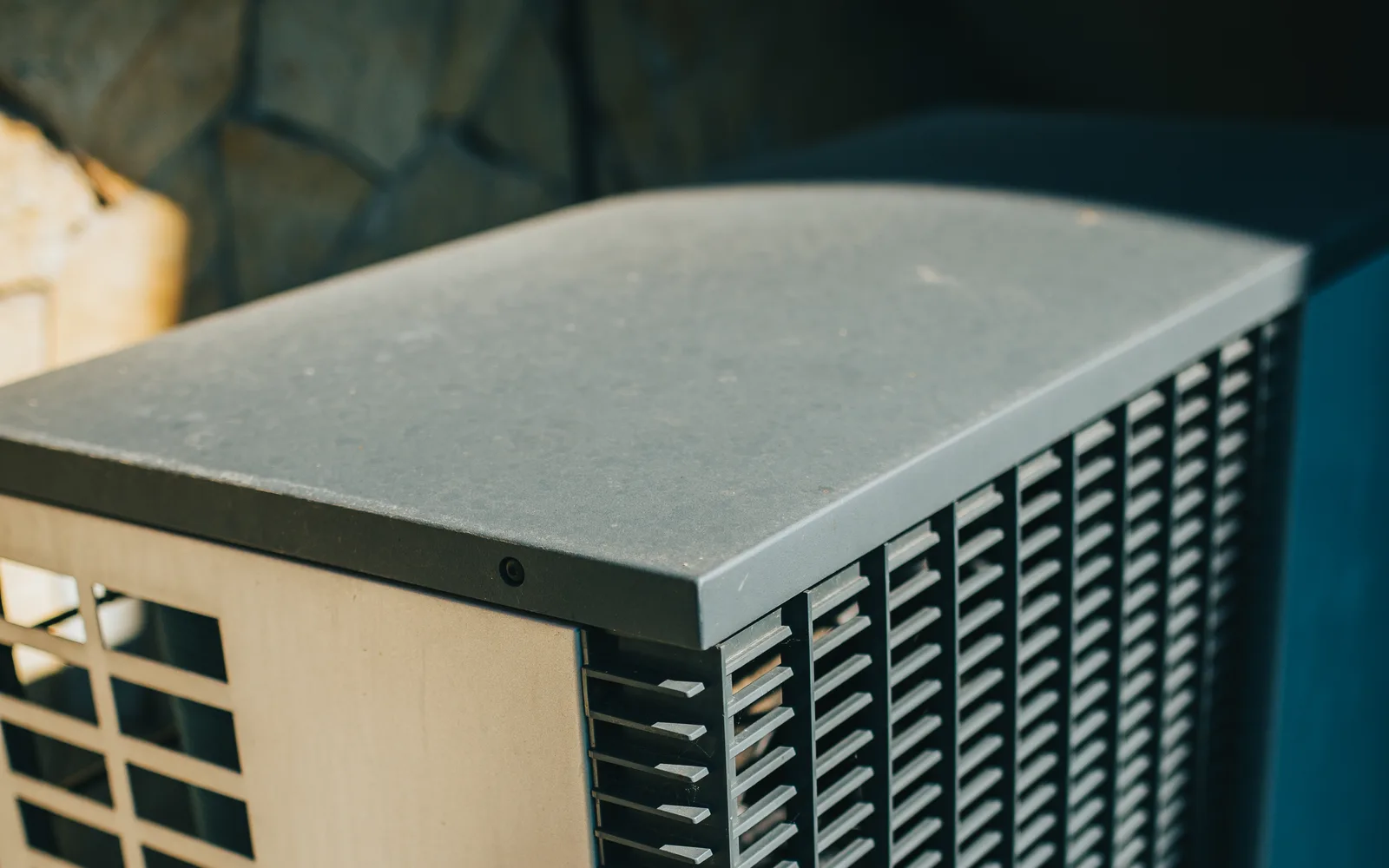 Licensed photo: outdoor residential air-conditioning unit in a garden area